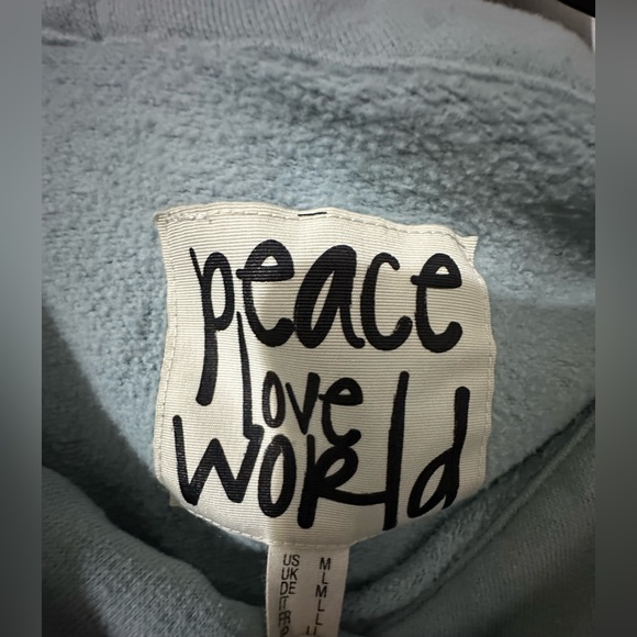 Peace Love World sweater is a size Medium. - Picture 3 of 7
